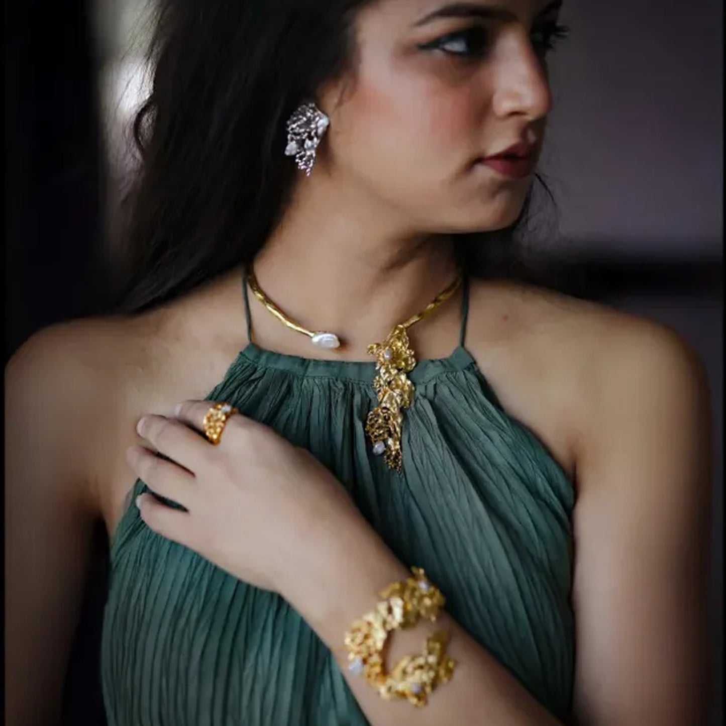 Rhyme Collar handcrafted in recycled brass with a large organic pendant, available in 22K gold or silver rhodium finish, shown against a neutral backdrop